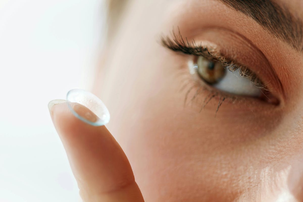contact lense being held near eye